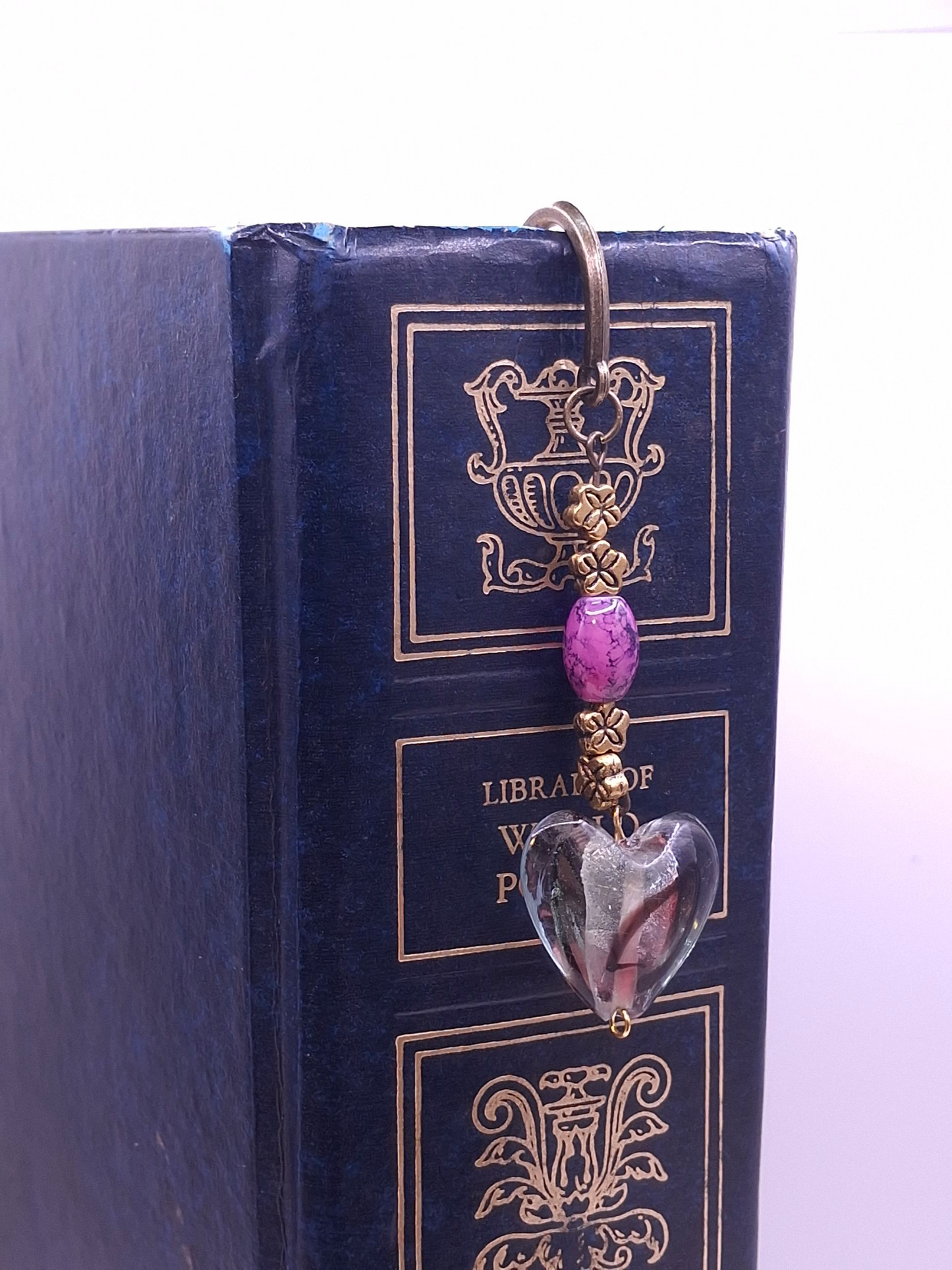 Brass-tone antiqued bookmark with purple marbled bead and translucent heart charm, and earrings